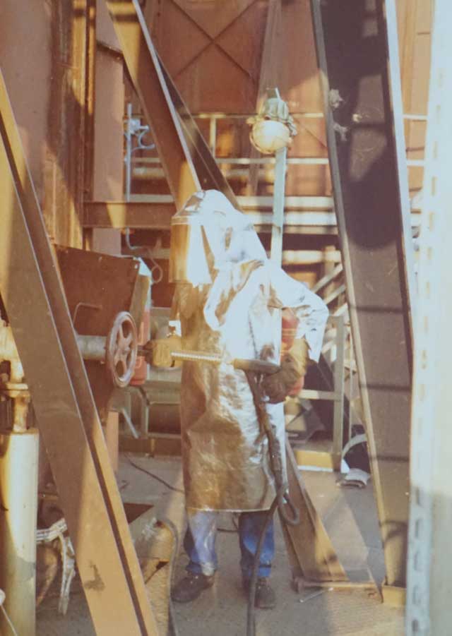 CTP technician in protective gear conducting online furnace cleaning using the NEUTRAMEX® process inside industrial facility